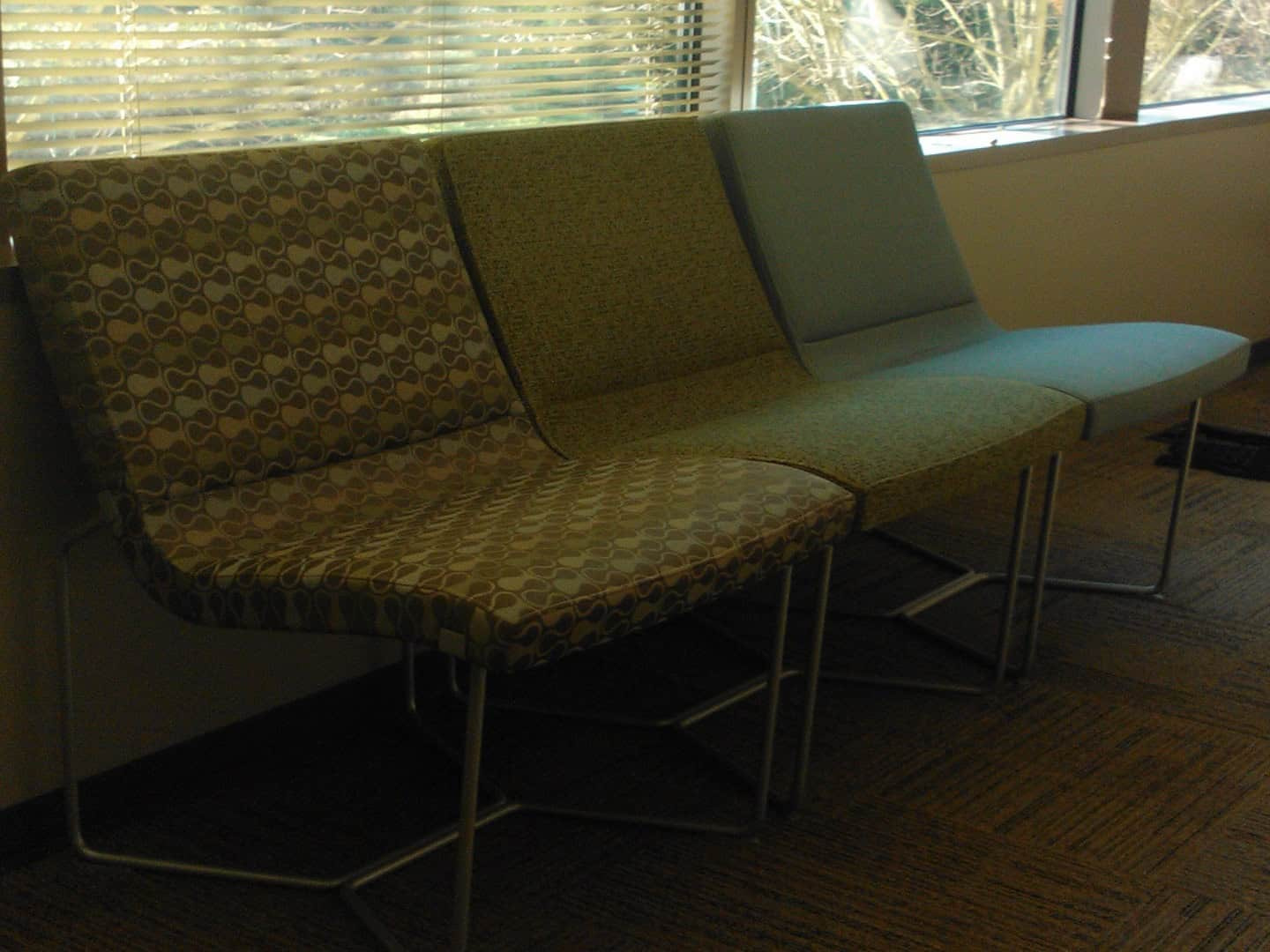 Three Green Chairs In An Office.