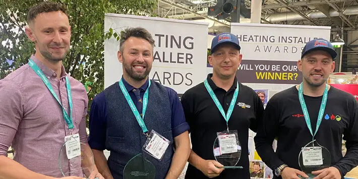 Four Trade Show Attendees Wearing Their Guest Passes.
