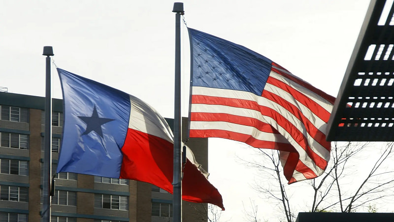 The flags of Texas and the United States.