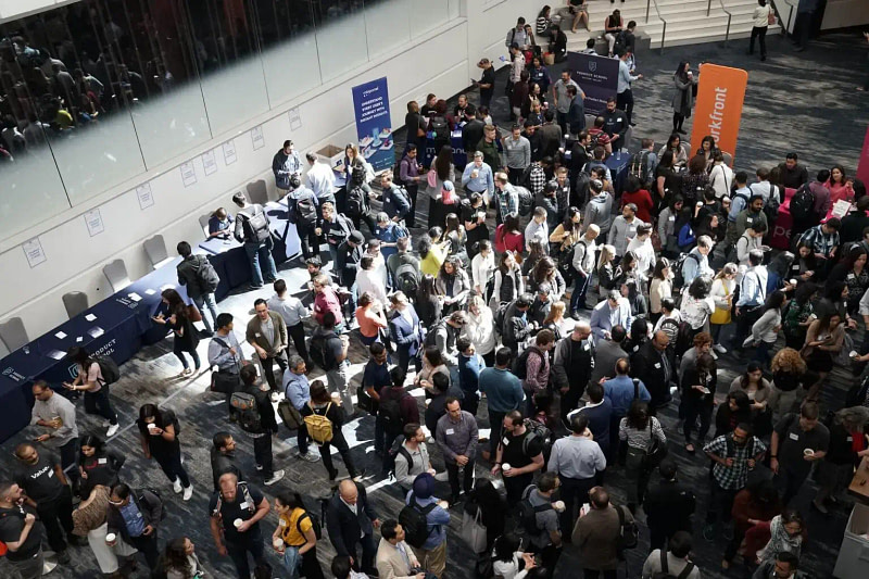 A dense crowd of attendees at a typical trade show event.