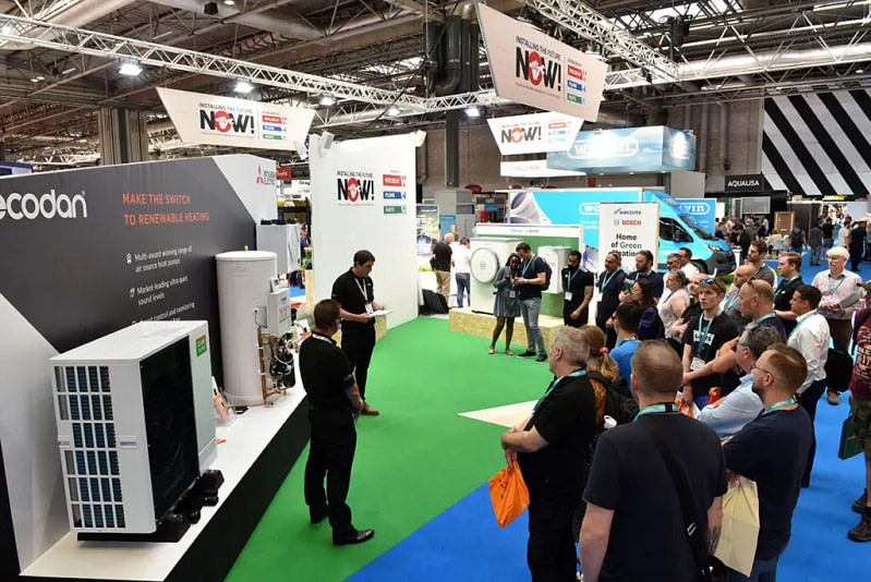 Visitors Watch A Demonstration At An Exhibition Stand At The Installershow.